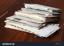 stock-photo-big-stack-of-mails-pile-of-papers-or-heap-of-letters-waiting-on-wooden-table-87375992.jpg
